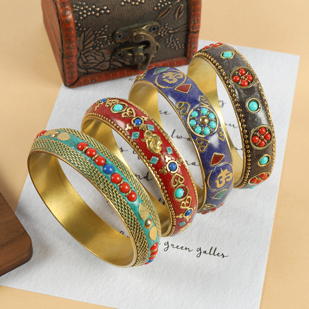 Vintage bohemian ethnic enamel bangle set with diverse colorful stone inlaid designs, featuring turquoise, red, blue styles, displayed on paper with a vintage box, ideal for boho fashion enthusiasts