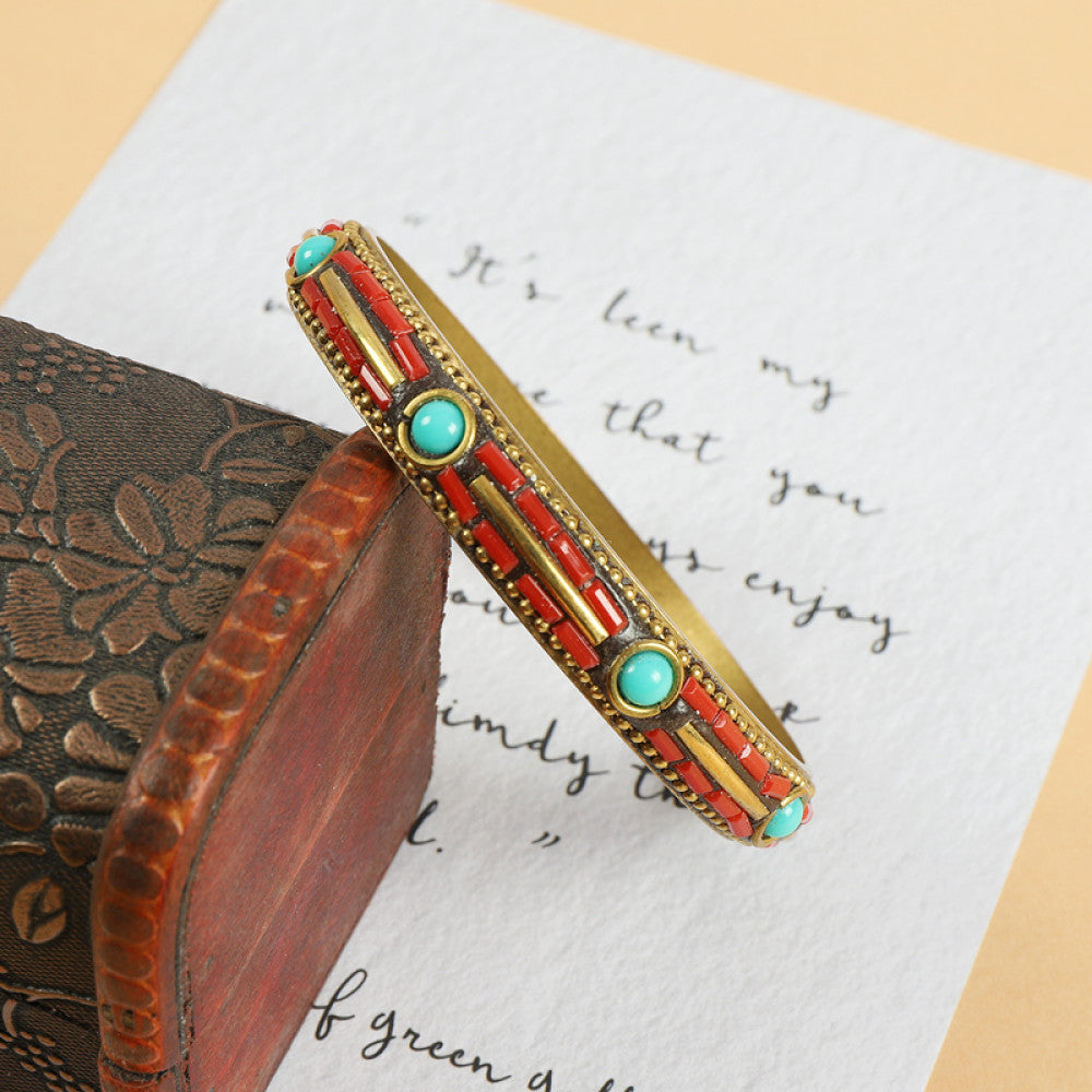 Vintage bohemian ethnic enamel bangle with turquoise and red stone inlays, gold-tone accents, displayed on a vintage box with decorative text, ideal for boho fashion enthusiasts 01