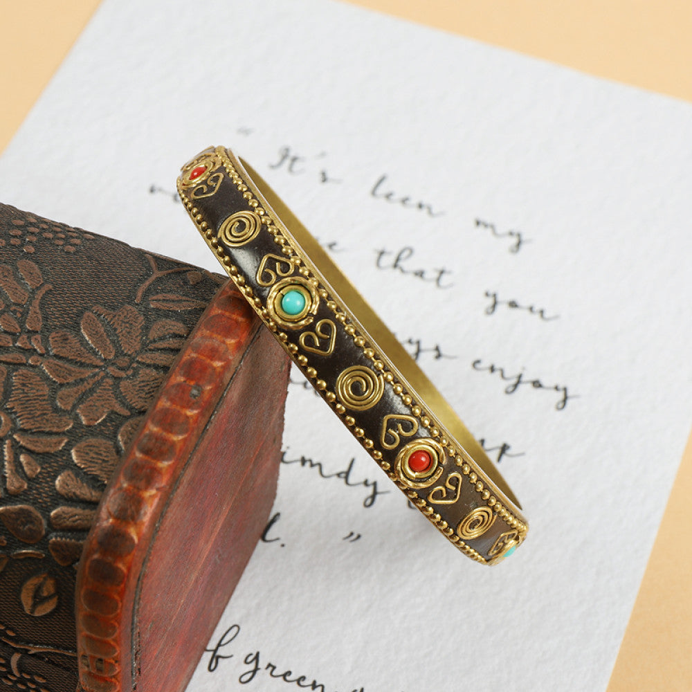 Vintage bohemian ethnic enamel bangle with turquoise and red stone inlays, gold-tone accents, displayed on a vintage box with decorative text, ideal for boho fashion enthusiasts 02