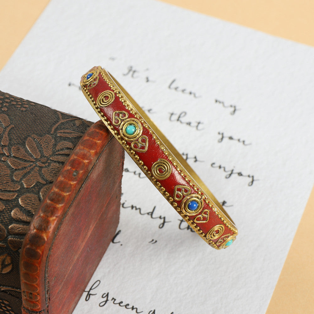 Vintage bohemian ethnic enamel bangle with turquoise and red stone inlays, gold-tone accents, displayed on a vintage box with decorative text, ideal for boho fashion enthusiasts 03