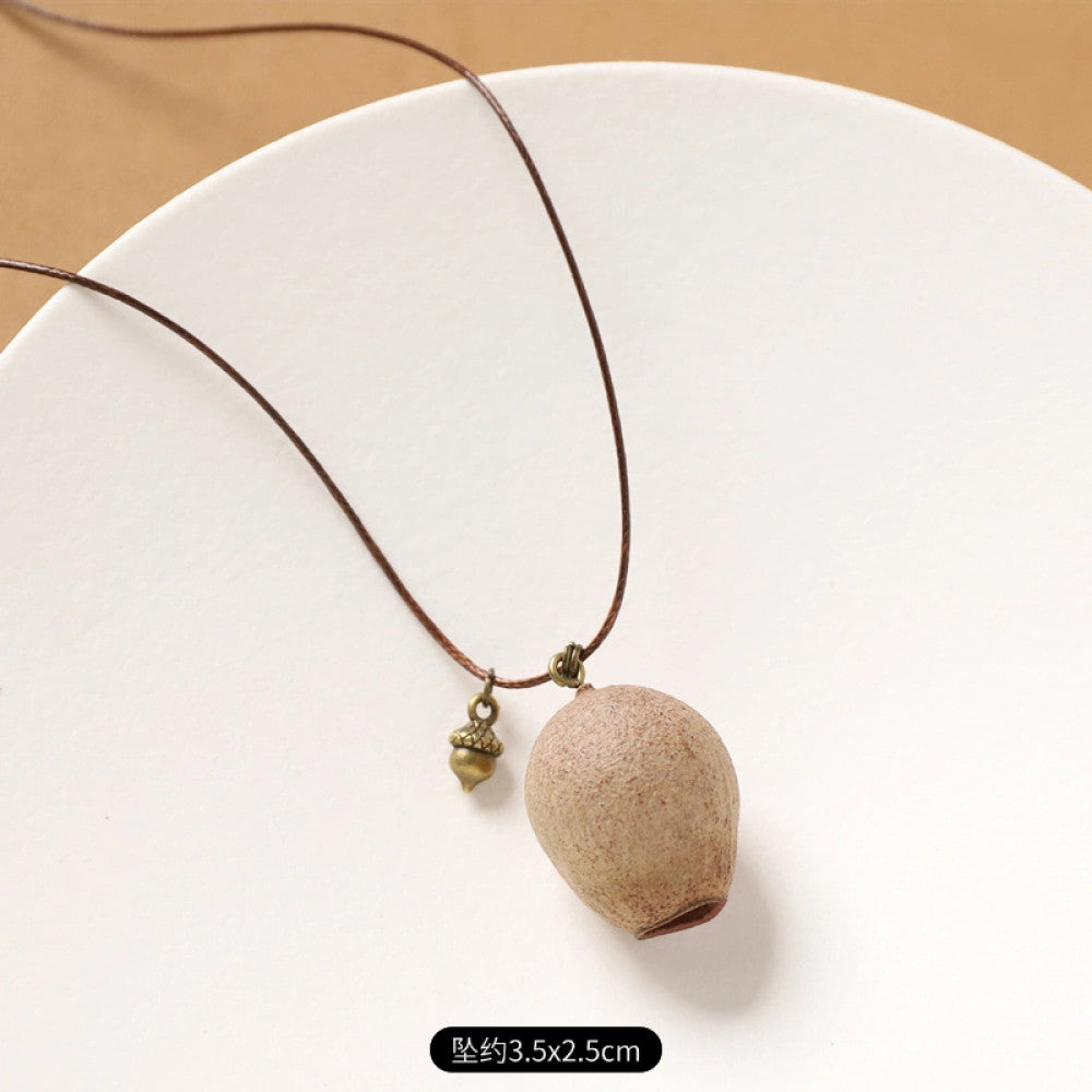 Vintage bohemian ethnic necklace with round natural stone pendant, featuring earthy brown tones and cord design, displayed on a neutral background with linen accent, ideal for boho fashion enthusiasts 11