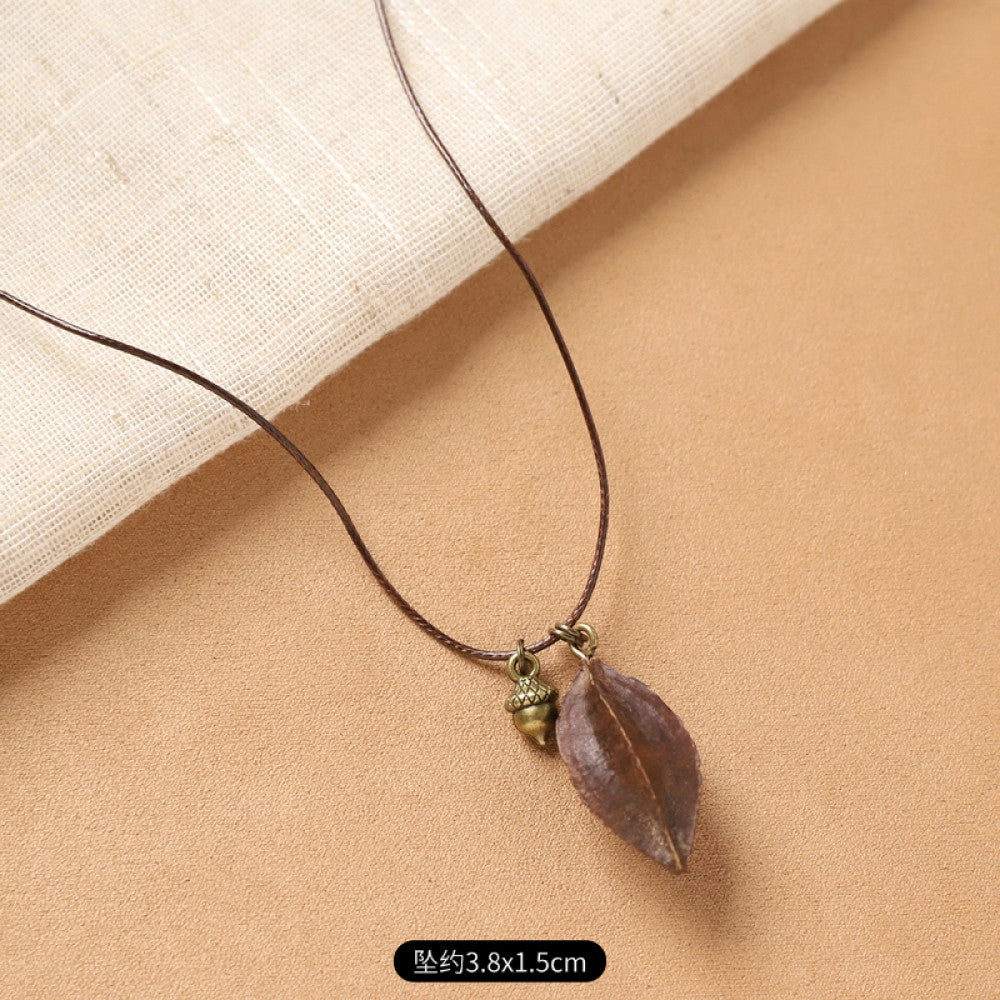 Vintage bohemian ethnic necklace with round natural stone pendant, featuring earthy brown tones and cord design, displayed on a neutral background with linen accent, ideal for boho fashion enthusiasts 12