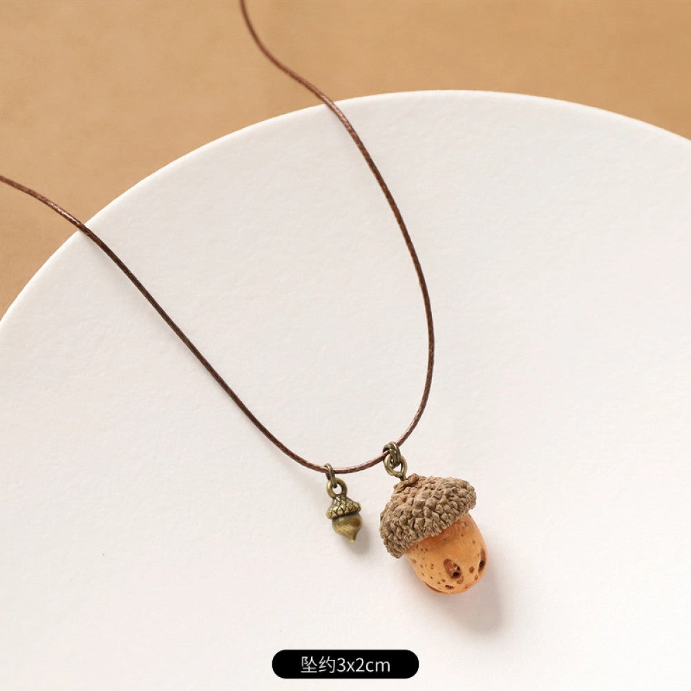 Vintage bohemian ethnic necklace with round natural stone pendant, featuring earthy brown tones and cord design, displayed on a neutral background with linen accent, ideal for boho fashion enthusiasts 13