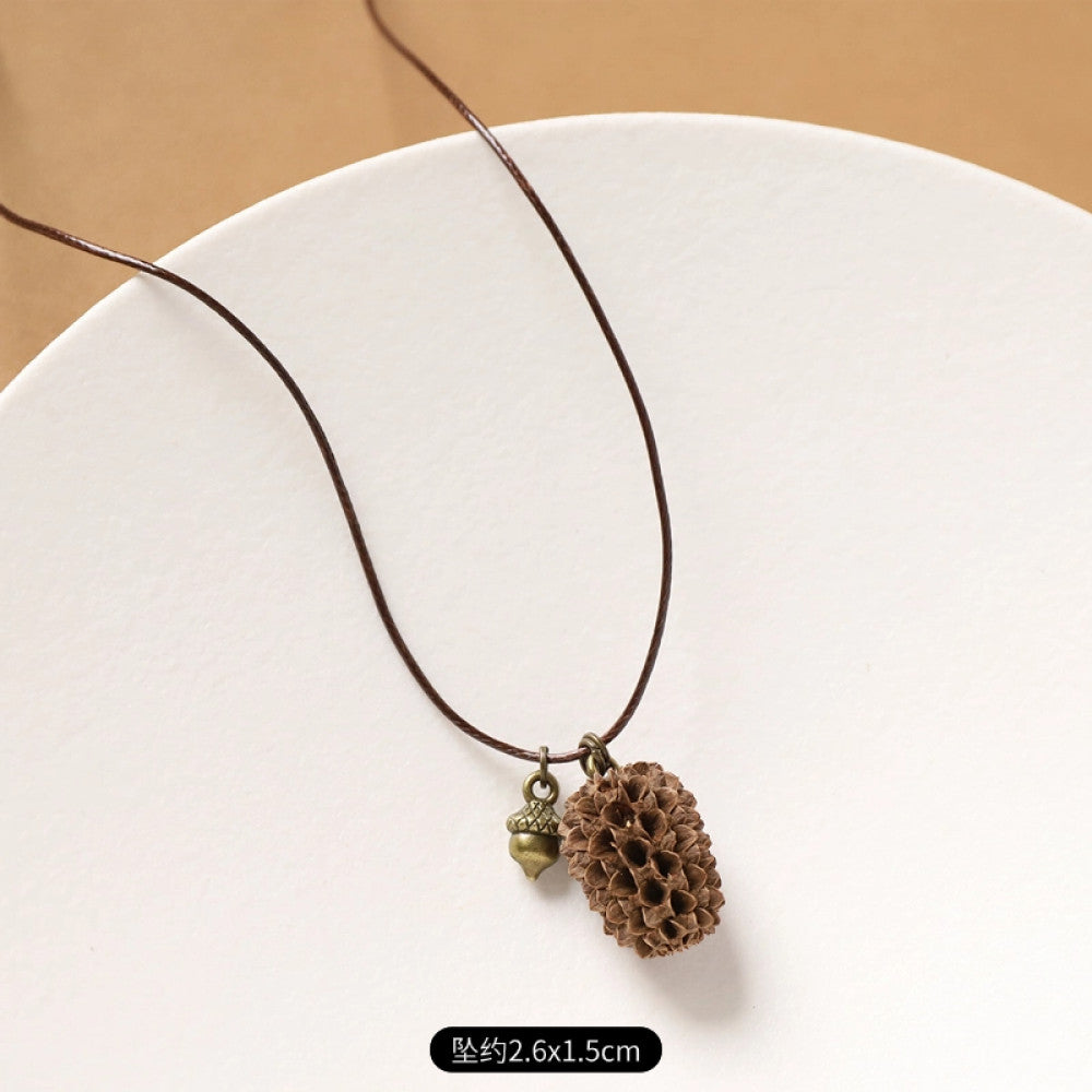 Vintage bohemian ethnic necklace with natural seed pendant, featuring earthy brown tones and cord design, displayed on a white plate against a neutral background, ideal for boho fashion enthusiasts 2