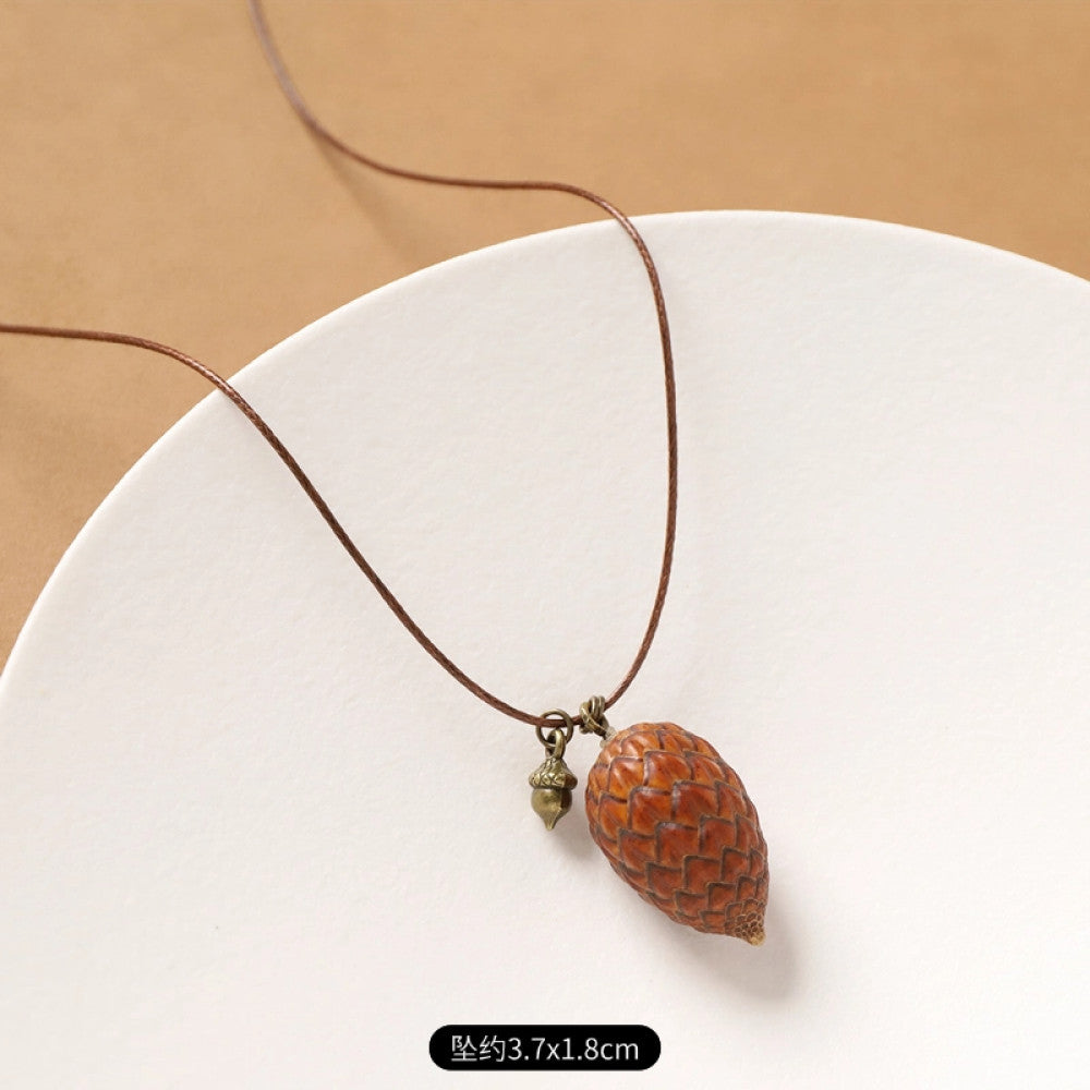 Vintage bohemian ethnic necklace with natural seed pendant, featuring earthy brown tones and cord design, displayed on a white plate against a neutral background, ideal for boho fashion enthusiasts 14