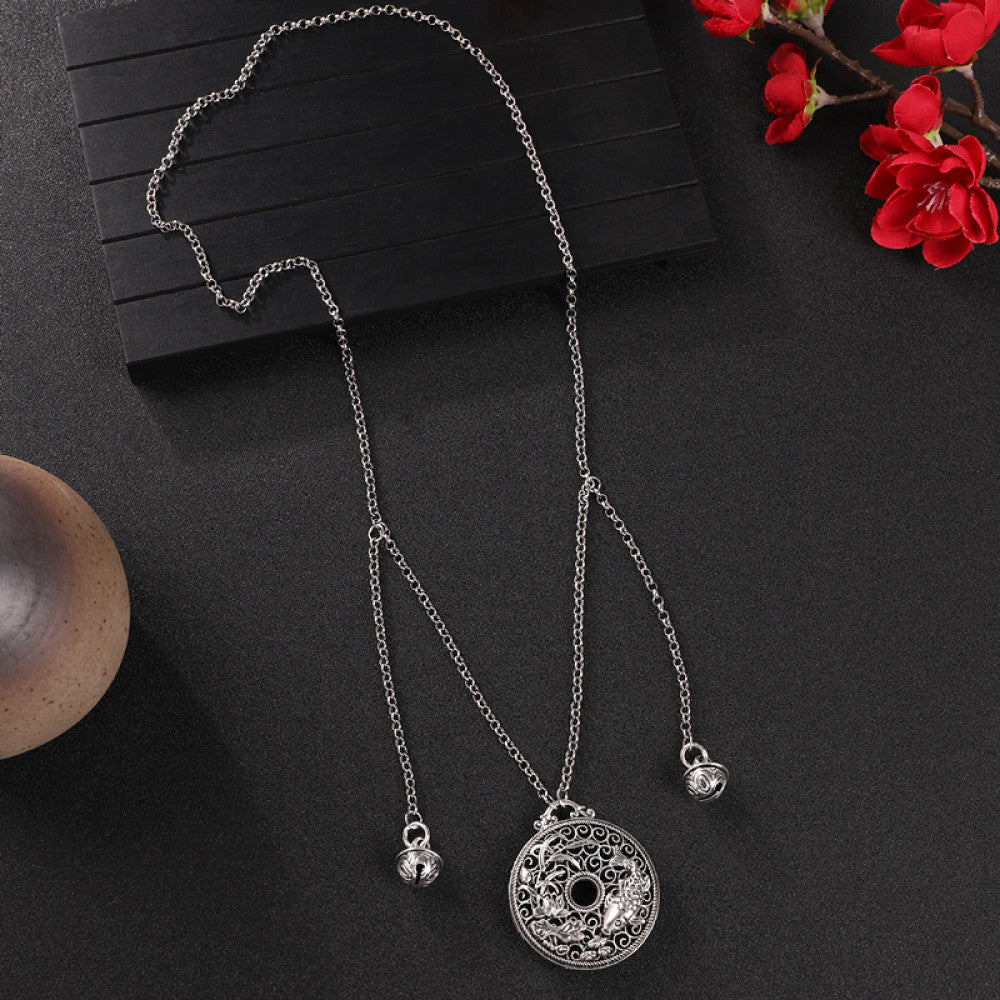 Vintage bohemian ethnic silver-tone necklace with Double Happiness pendant and filigree details, displayed on a dark background with red flowers, ideal for boho fashion and cultural-inspired styling 01