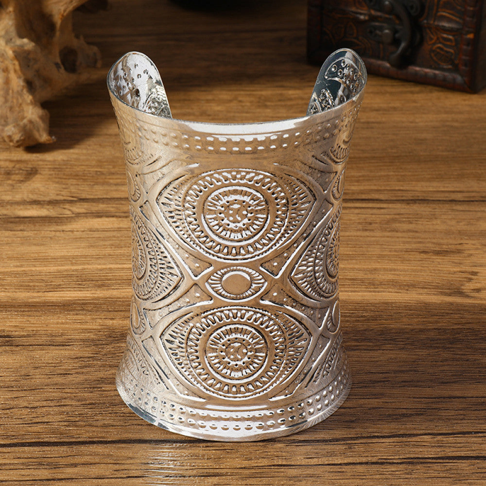 Vintage bohemian ethnic silver-tone engraved cuff bracelet with ornate tribal designs, displayed on a wooden surface with decorative elements, ideal for boho and ethnic fashion enthusiasts 02