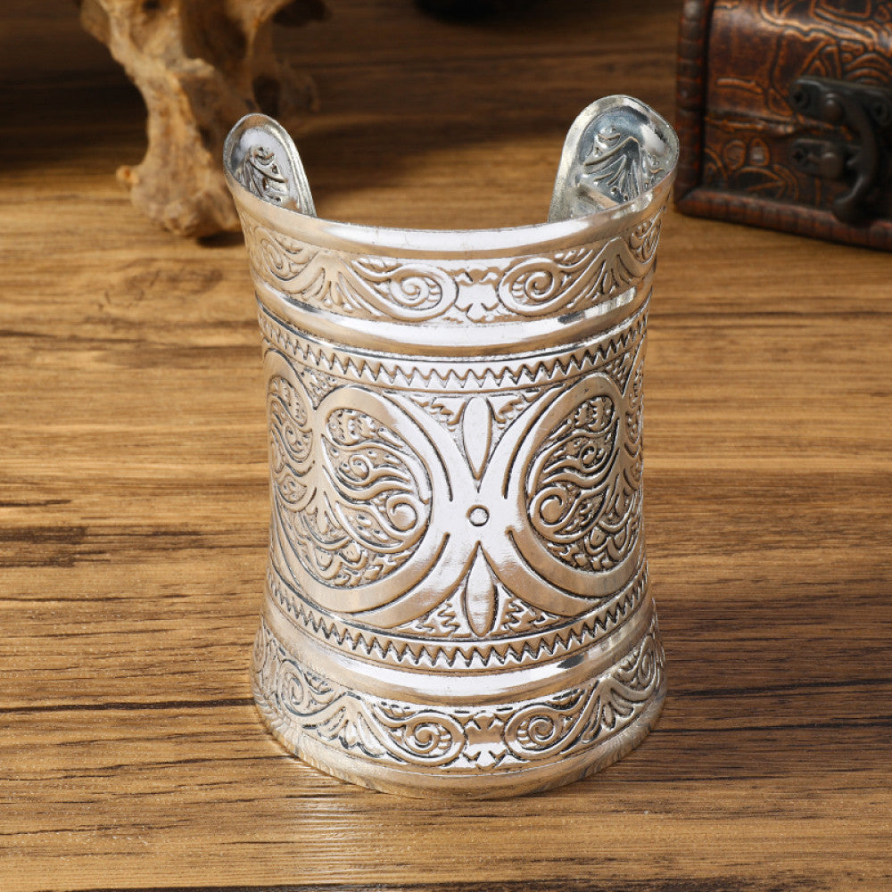 Vintage bohemian ethnic silver-tone engraved cuff bracelet with ornate tribal designs, displayed on a wooden surface with decorative elements, ideal for boho and ethnic fashion enthusiasts 05