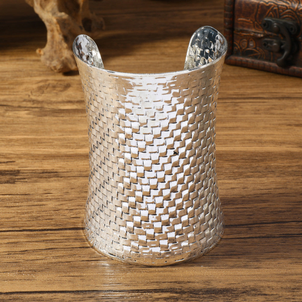 Vintage bohemian ethnic silver-tone cuff bracelet with intricate tribal animal engravings, displayed on a wooden surface with decorative elements, ideal for boho and ethnic fashion enthusiasts 03