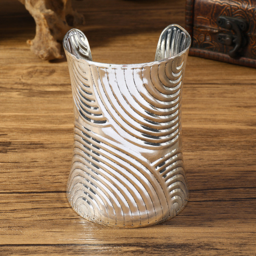 Vintage bohemian ethnic silver-tone cuff bracelet with intricate tribal animal engravings, displayed on a wooden surface with decorative elements, ideal for boho and ethnic fashion enthusiasts 07