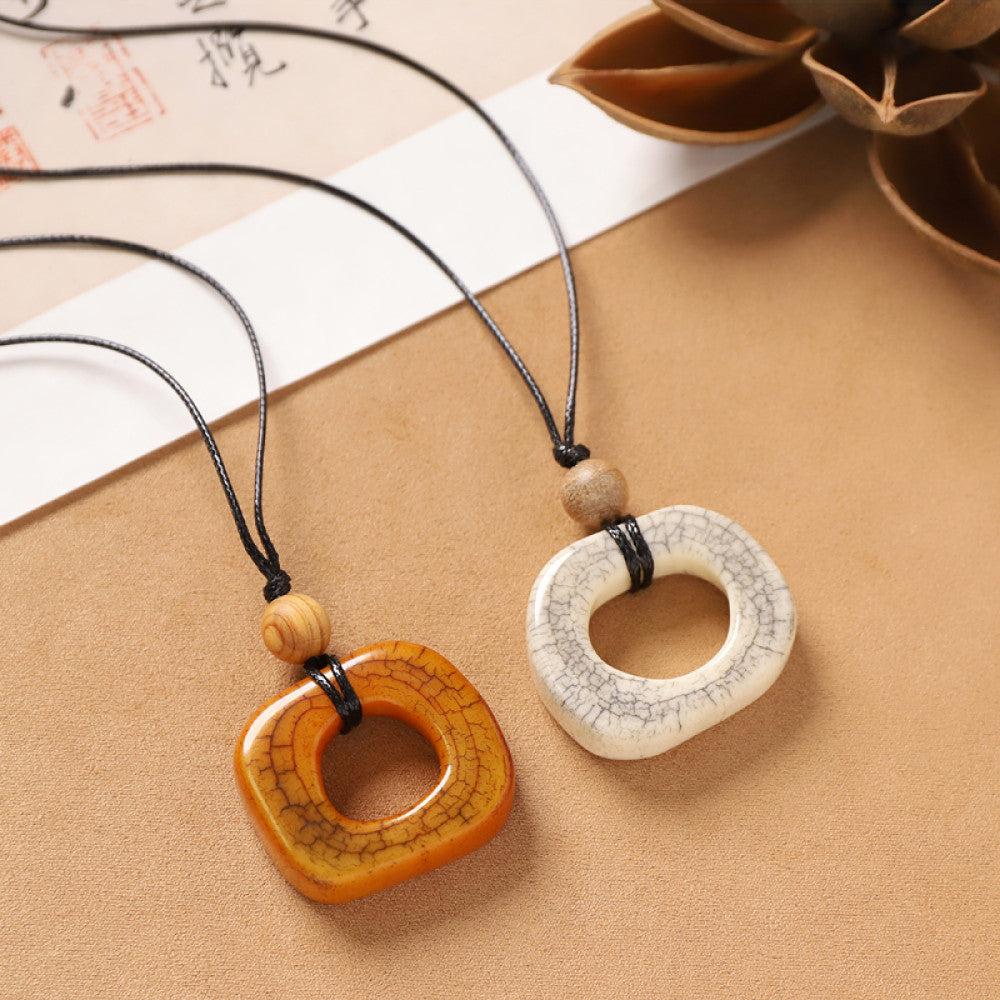 Vintage bohemian ethnic square pendant necklace set in two tones, featuring textured earthy and off-white pendants with black cord, displayed with traditional Chinese calligraphy and decorative flower, ideal for boho fashion enthusiasts 