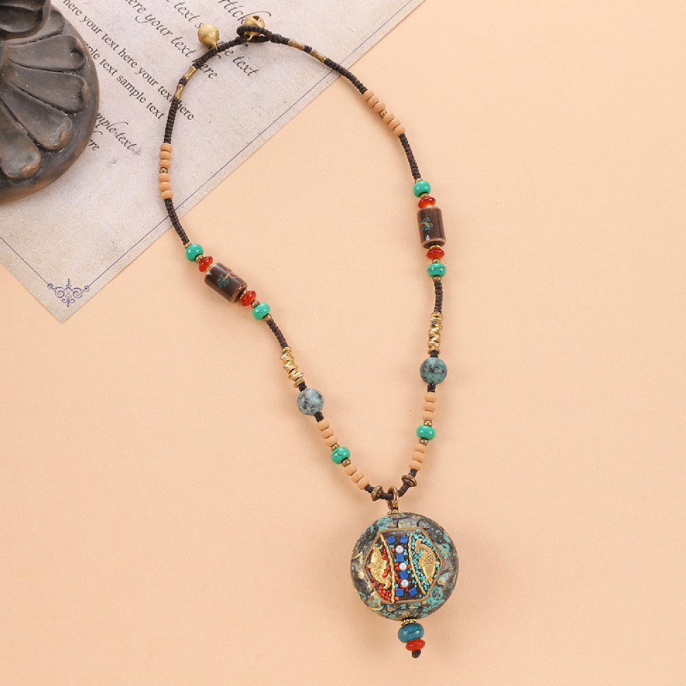 Vintage bohemian ethnic tribal beaded necklace with intricate colorful pendant and multi-color beads, ideal for boho fashion, displayed on a neutral background with vintage paper accent 03