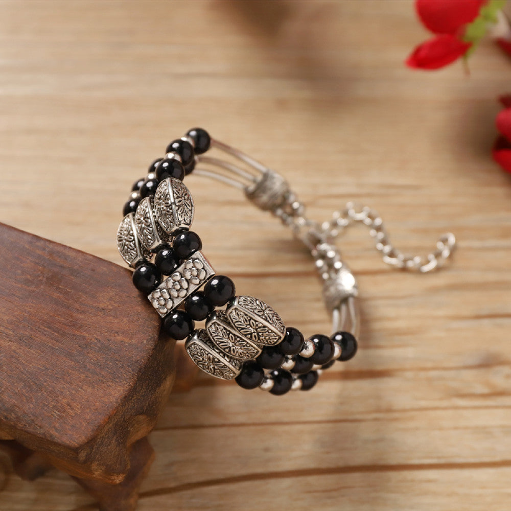 Vintage bohemian ethnic bracelet with turquoise beads and silver leaf accents, displayed on a wooden surface, ideal for boho fashion enthusiasts 01