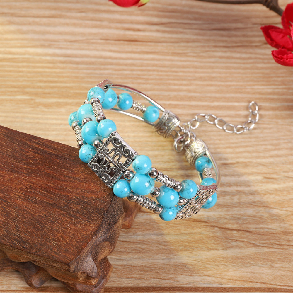 Vintage bohemian ethnic bracelet with turquoise beads and silver leaf accents, displayed on a wooden surface, ideal for boho fashion enthusiasts 05