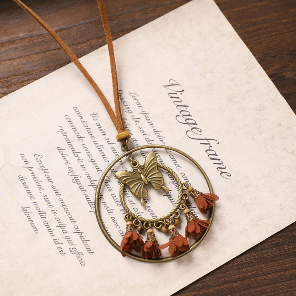 Vintage bohemian floral tassel necklace with beaded and fringe details, featuring earthy tones and intricate design, displayed on vintage paper, ideal for boho fashion enthusiasts 01