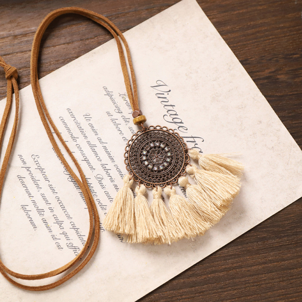 Vintage bohemian floral tassel necklace with beaded and fringe details, featuring earthy tones and intricate design, displayed on vintage paper, ideal for boho fashion enthusiasts 02