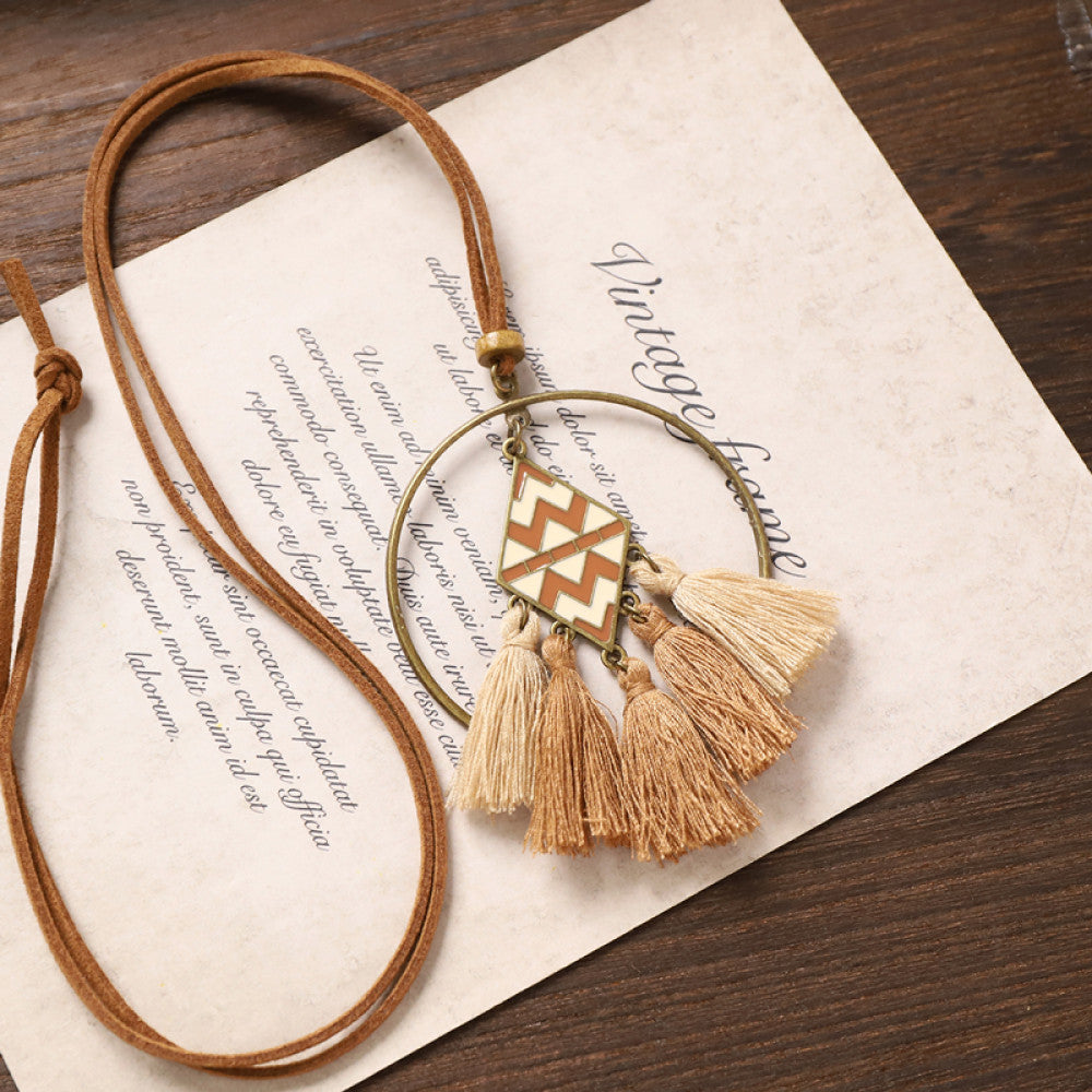 Vintage bohemian floral tassel necklace with beaded and fringe details, featuring earthy tones and intricate design, displayed on vintage paper, ideal for boho fashion enthusiasts 06