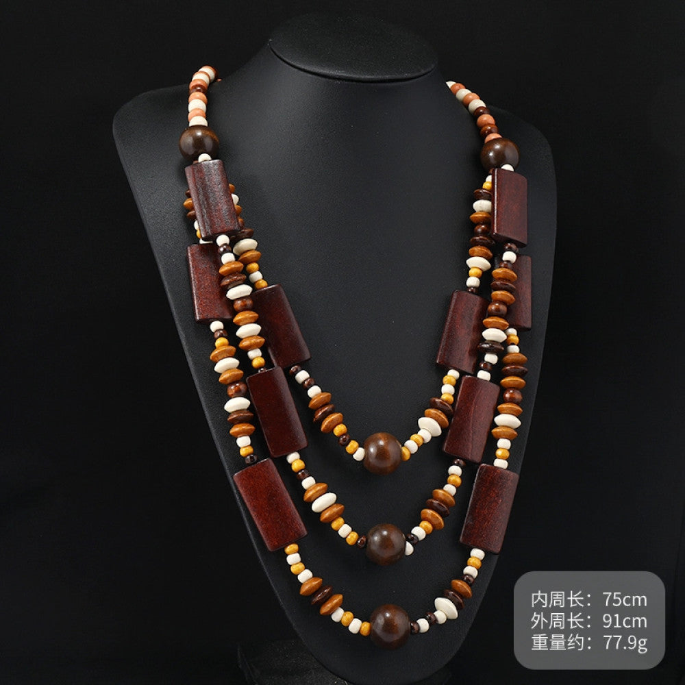 Vintage bohemian multi-layer wood beaded necklace with earthy tones, featuring intricate layered design, ideal for boho ethnic fashion, displayed on a black mannequin against a dark background 06