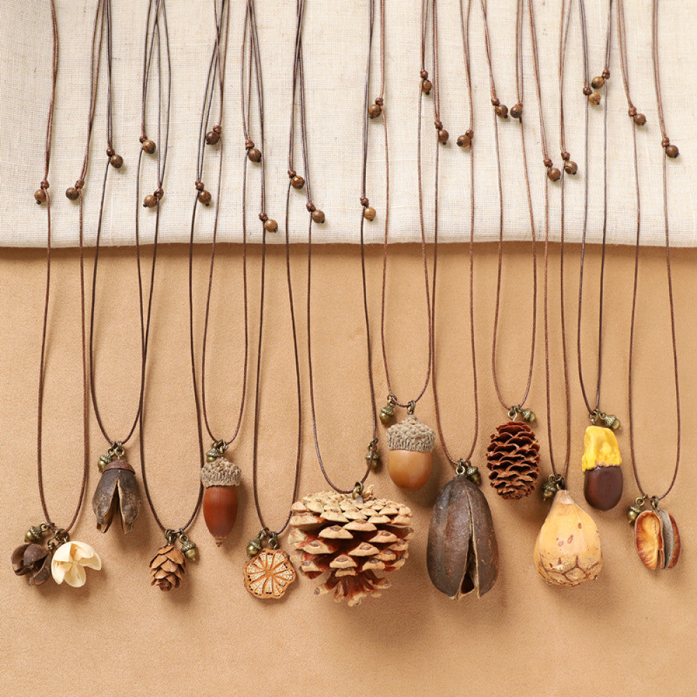 Assorted bohemian vintage natural element necklace set with acorn, pinecone, seed, and floral pendants, displayed against a neutral background, ideal for boho and nature-inspired fashion enthusiasts