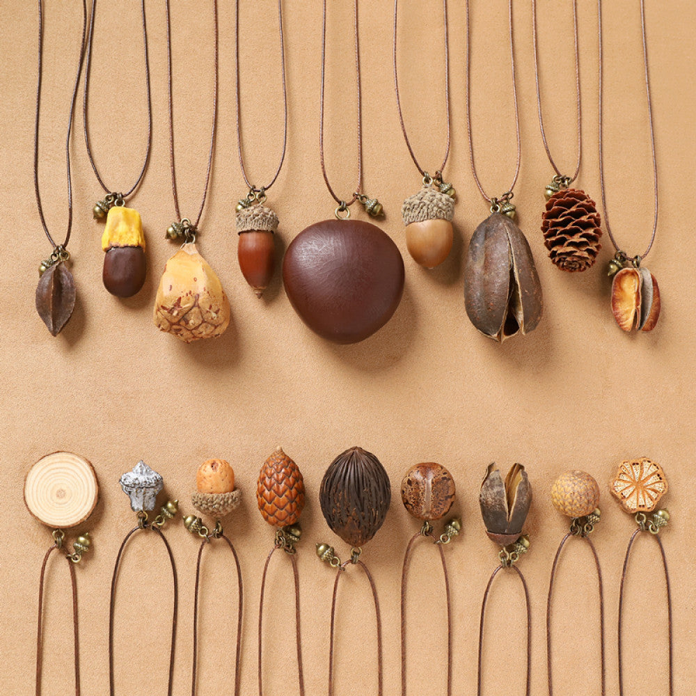 Assorted bohemian vintage natural element necklace set with acorn, pinecone, seed, and floral pendants, displayed against a neutral background, ideal for boho and nature-inspired fashion enthusiasts 01