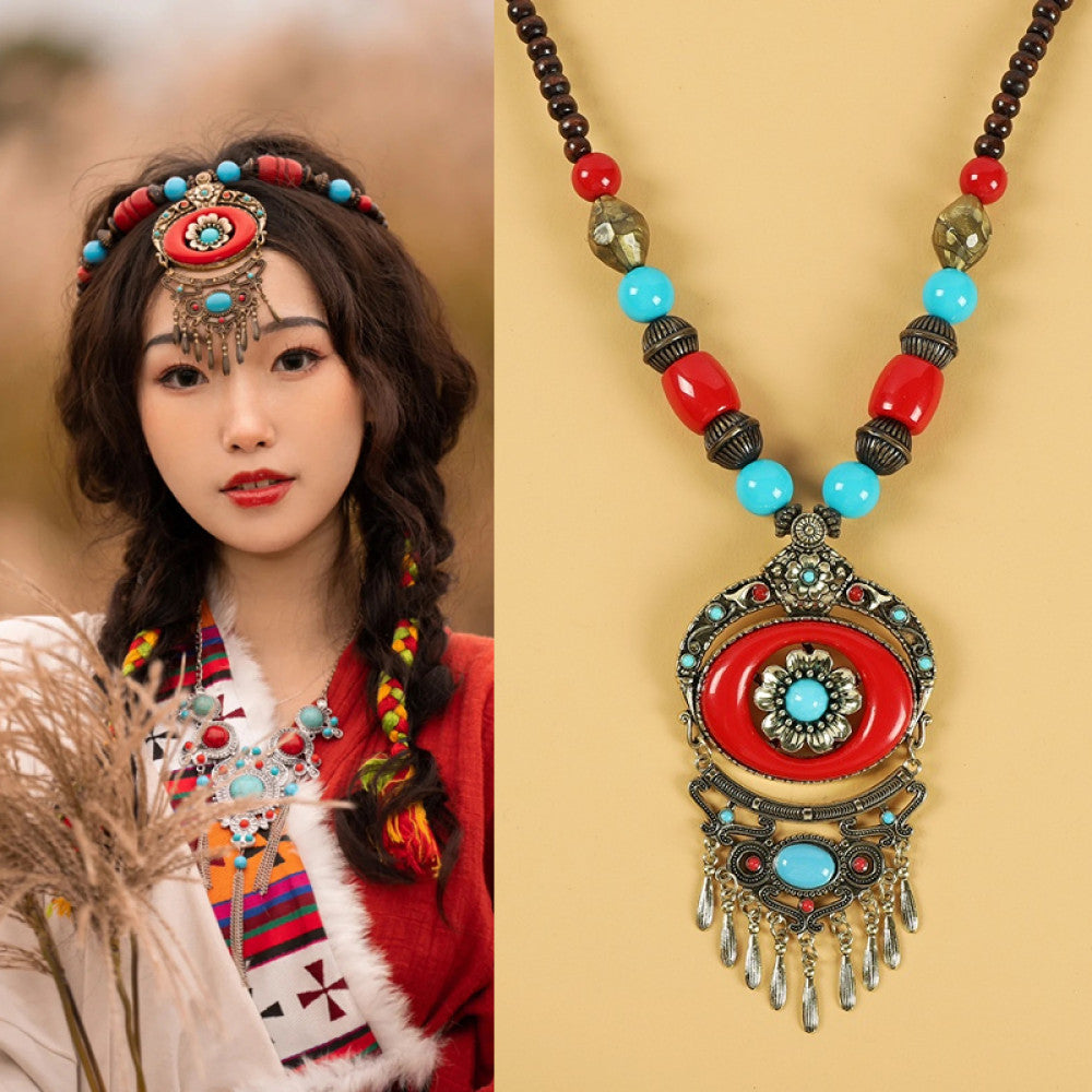 Ethnic tribal style necklace with large red pendant, colorful beaded design, and tassel details, perfect for bohemian vintage fashion, showcased alongside a model in traditional ethnic attire 02