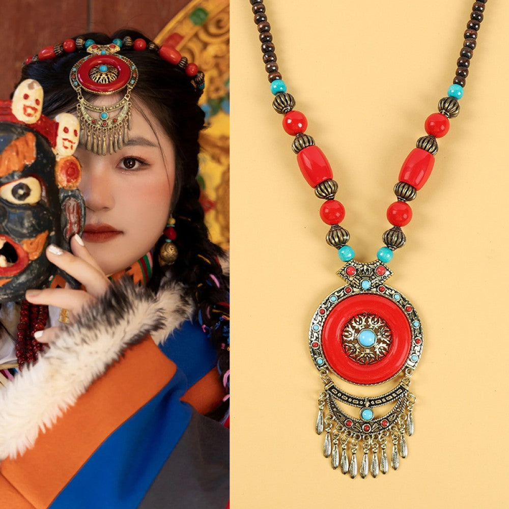 Ethnic tribal style necklace with large red pendant, colorful beaded design, and tassel details, ideal for bohemian vintage fashion, displayed alongside a model in traditional ethnic attire 07