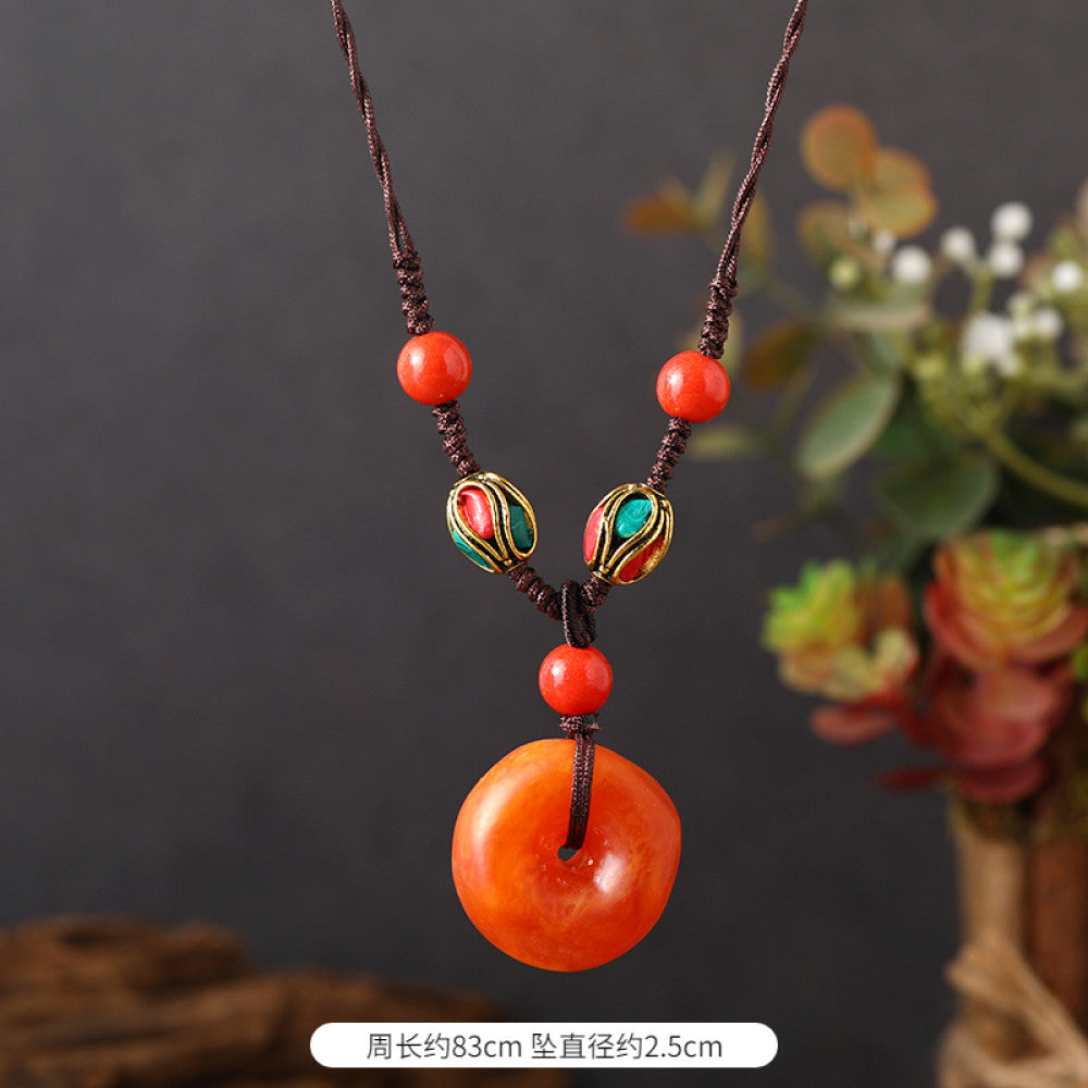 Vintage bohemian ethnic tribal necklace featuring a red circular pendant, intricate silver detailing, and braided rope design, perfect for boho fashion, showcased against a neutral background 04