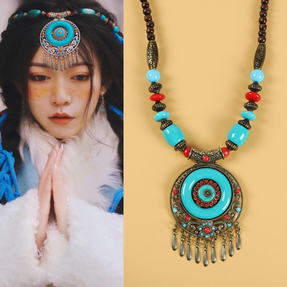 Ethnic tribal style necklace with large circular turquoise pendant, colorful beaded design, and tassel details, ideal for bohemian vintage fashion, displayed alongside a model in traditional ethnic attire