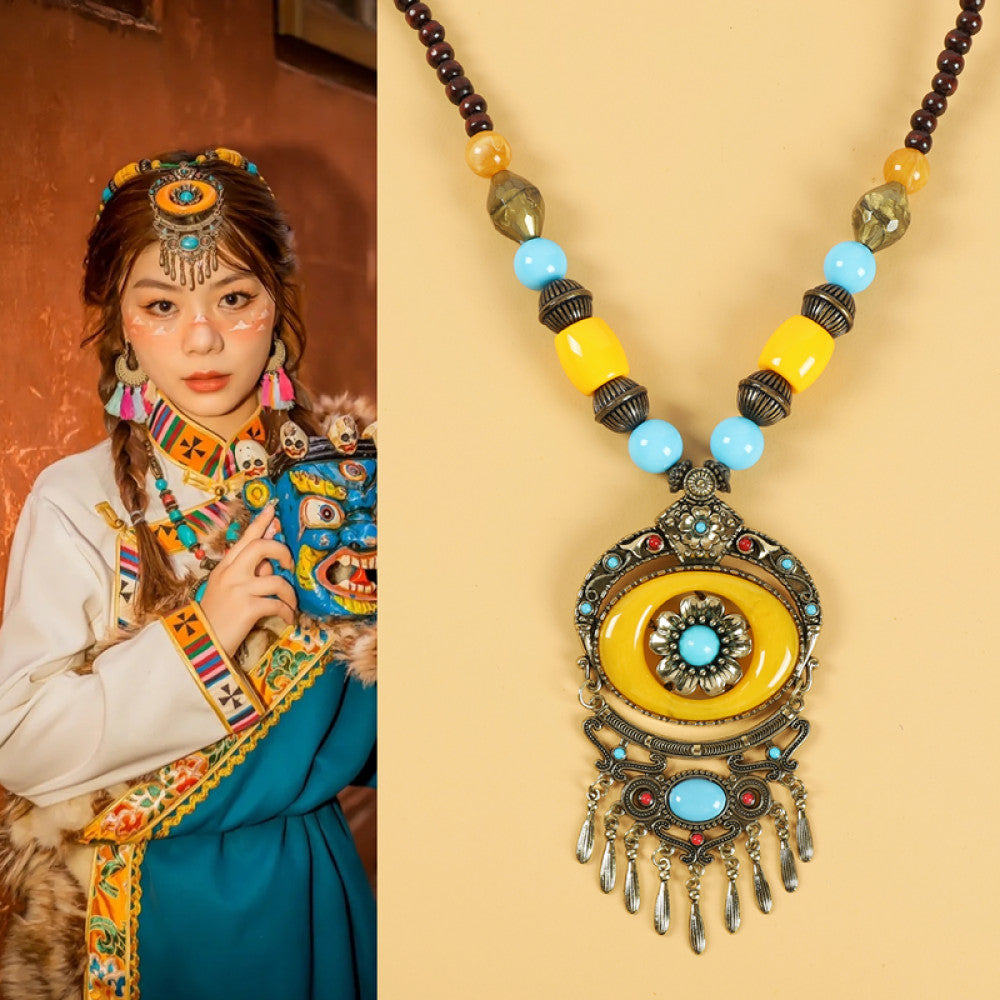 Ethnic tribal style necklace with large yellow pendant, colorful beaded design, and tassel details, ideal for bohemian vintage fashion, displayed alongside a model in traditional ethnic attire 03
