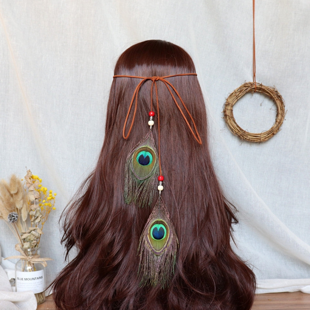 Boho bohemian macramé hair band (worn on long dark brown hair) featuring abundant white feather tassels, wooden bead accents, displayed with dried flower vase & woven wreath decor 04