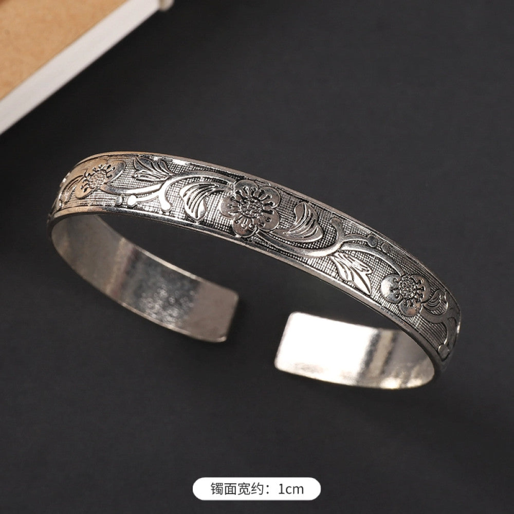Vintage boho chic silver-tone filigree cuff bracelet with intricate floral designs, styled on a black surface, perfect for bohemian and ethnic fashion lovers in the US 06