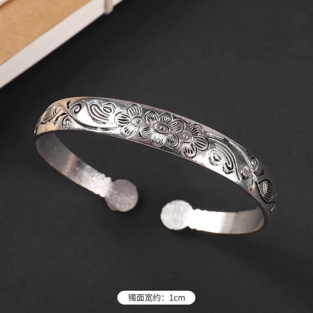 Vintage boho chic silver-tone filigree cuff bracelet with intricate floral designs, styled on a black surface, perfect for bohemian and ethnic fashion lovers in the US 07