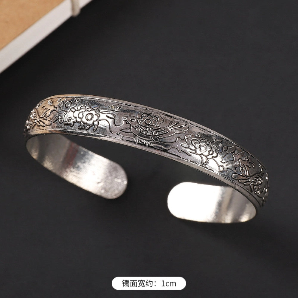 Vintage boho chic silver-tone filigree cuff bracelet with intricate floral designs, styled on a black surface, perfect for bohemian and ethnic fashion lovers in the US 08