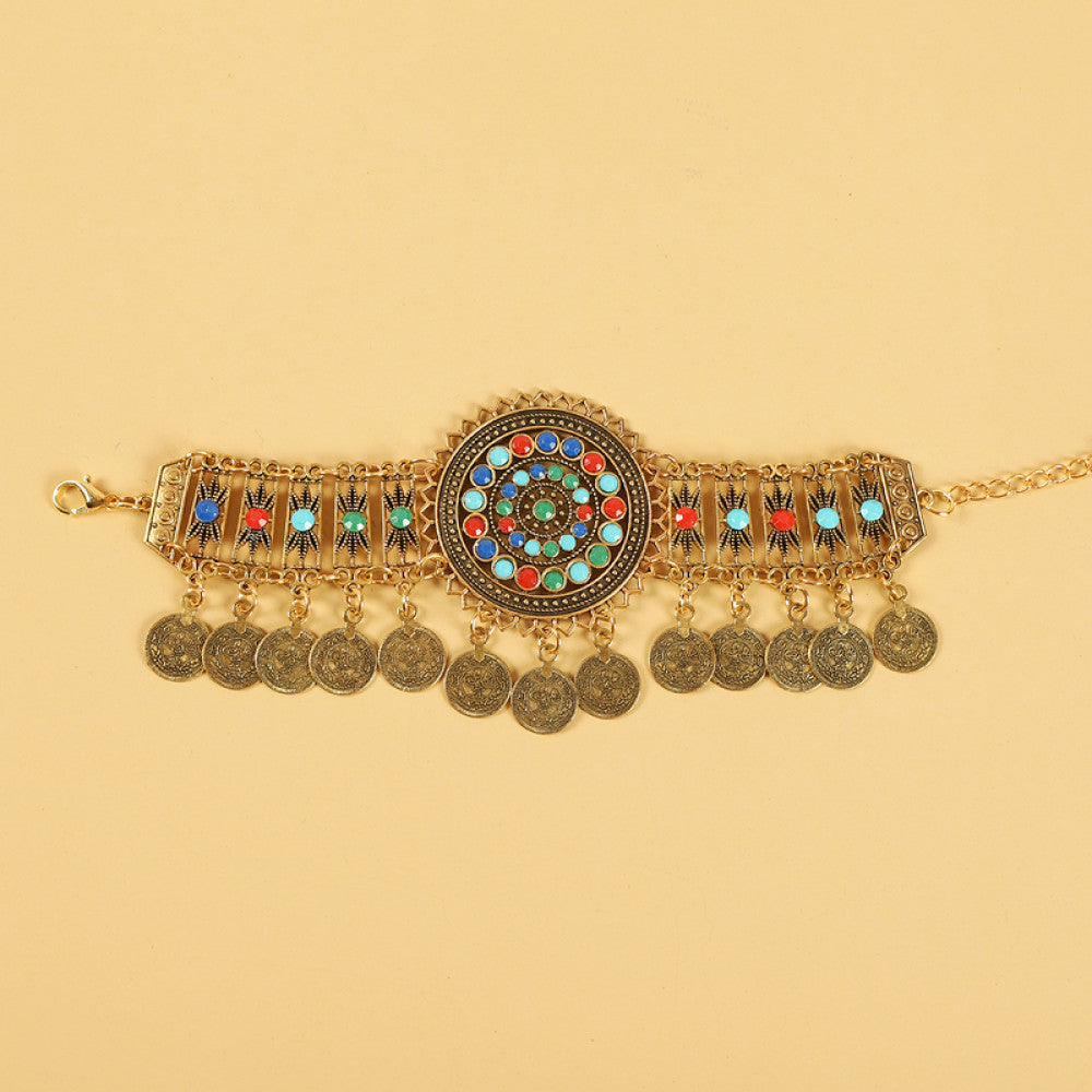 Boho ethnic gold-tone decorative belt featuring a vibrant colorful mosaic centerpiece, multi-color gemstone accents, and layered coin tassel pendants, displayed on a light yellow background, ideal for bohemian and festival fashion styling in the US