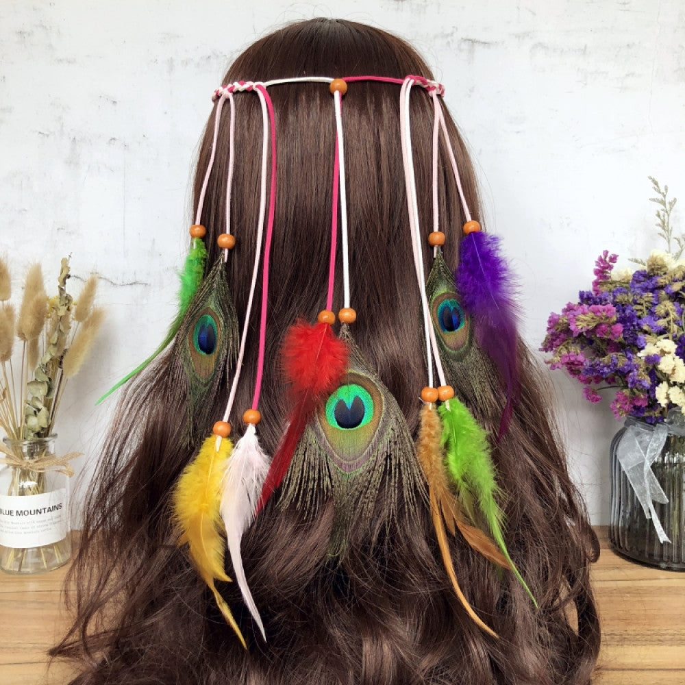Boho leather cord hair band featuring a vibrant peacock feather, multi color feather tassels, and bead accents  displayed on a wooden surface with dried fresh flower arrangements, ideal for bohemian festival fashion enthusiasts in the US 05