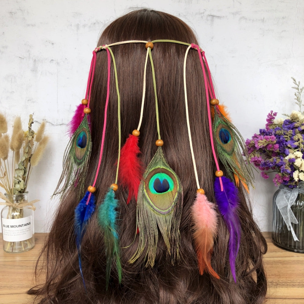Boho leather cord hair band featuring a vibrant peacock feather, multi color feather tassels, and bead accents  displayed on a wooden surface with dried fresh flower arrangements, ideal for bohemian festival fashion enthusiasts in the US 06