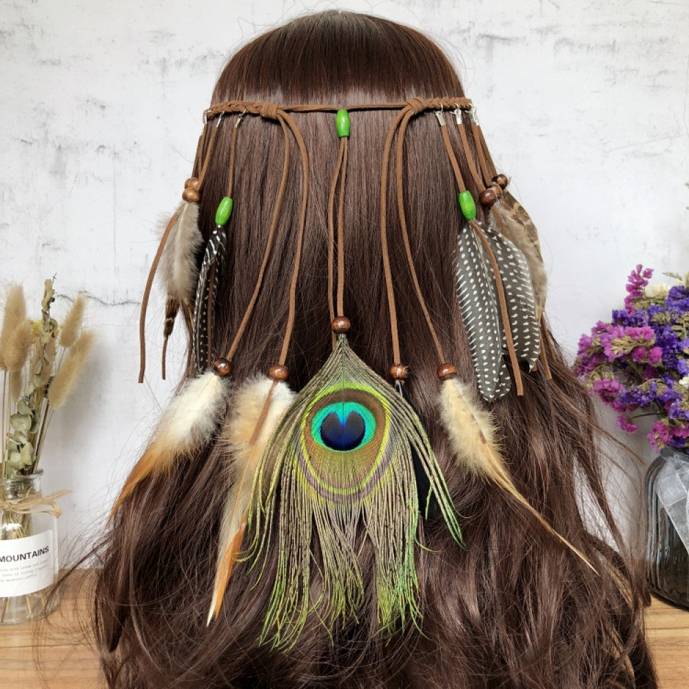 Boho leather cord hair band featuring a vibrant peacock feather, multi color feather tassels, and bead accents  displayed on a wooden surface with dried fresh flower arrangements 08