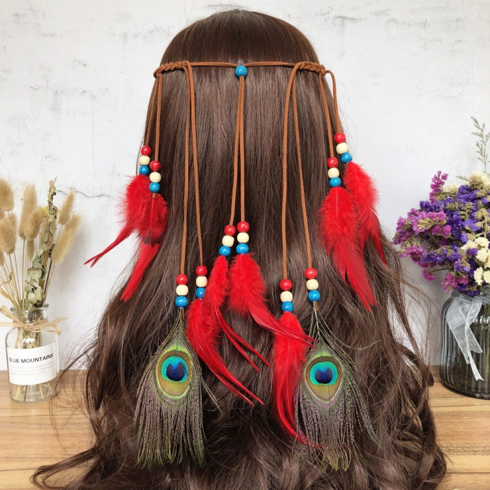 Boho leather cord hair band featuring a vibrant peacock feather, multi color feather tassels, and bead accents  displayed on a wooden surface with dried fresh flower arrangements 12