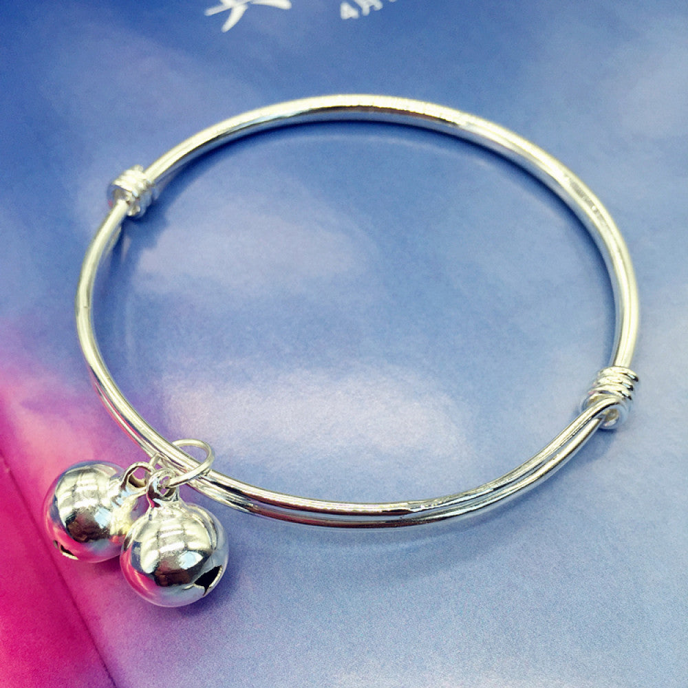 Boho minimalist polished silver adjustable bangle, styled on a colorful surface, ideal for minimalist and bohemian fashion enthusiasts 01