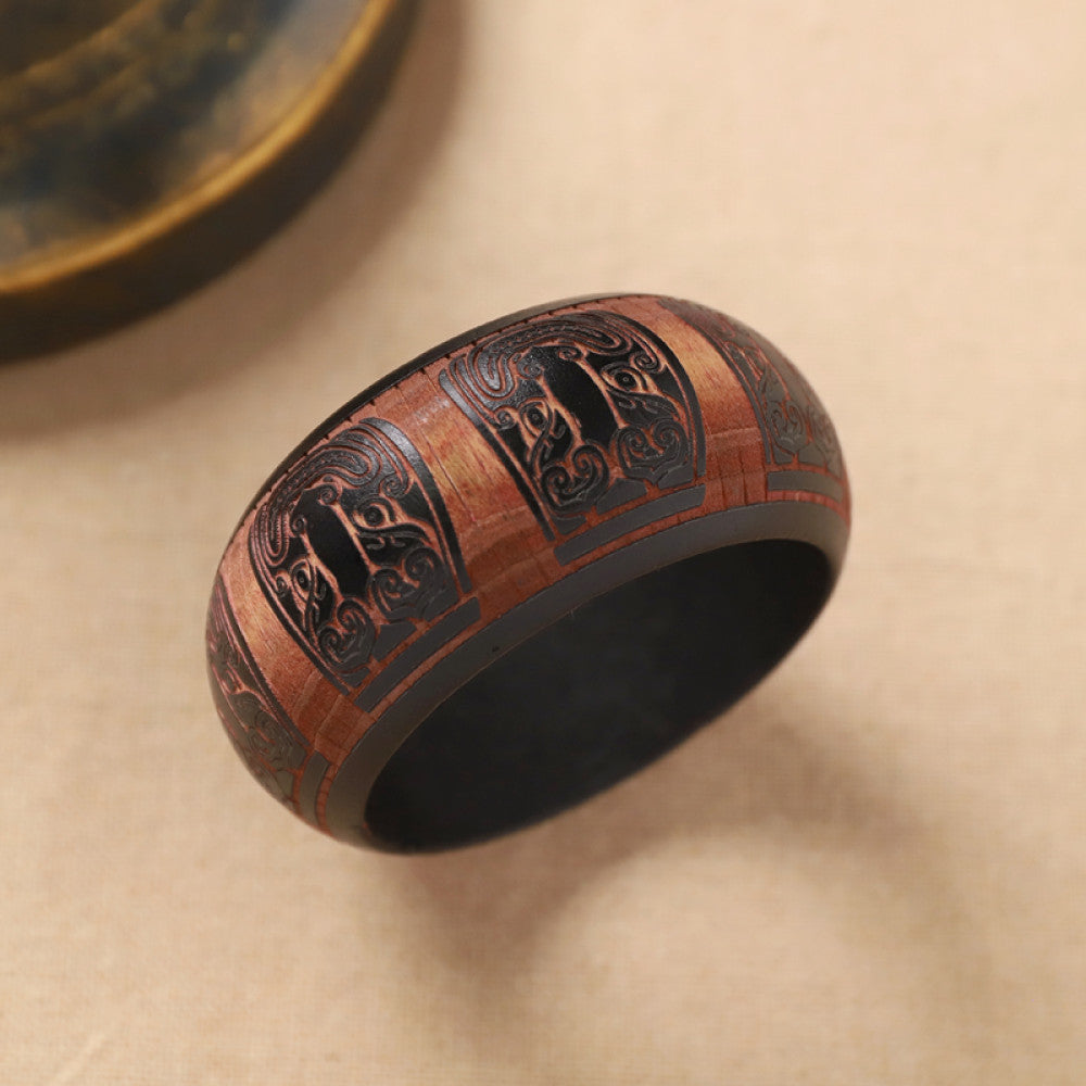 Boho vintage ethnic black bangle with sun motif filigree designs, styled on neutral surface, ideal for bohemian and tribal fashion enthusiasts in the US 05