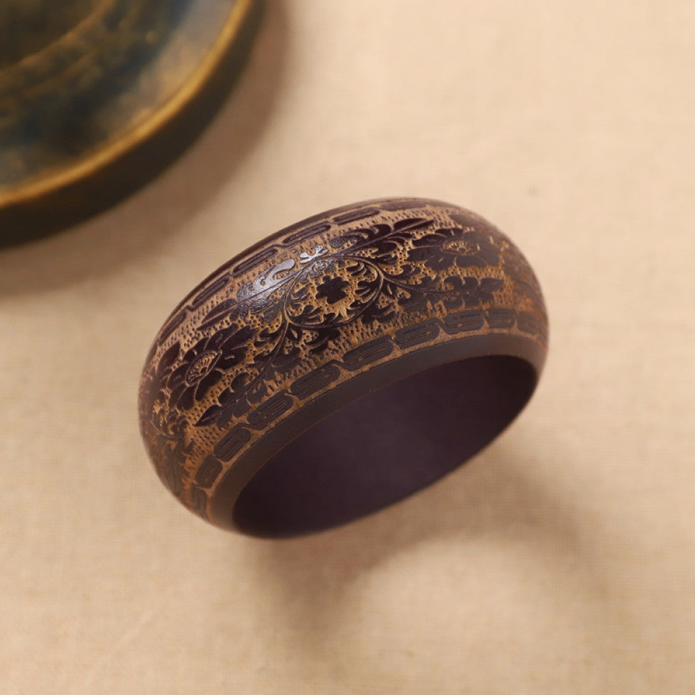 Boho vintage ethnic black bangle with sun motif filigree designs, styled on neutral surface, ideal for bohemian and tribal fashion enthusiasts in the US 06