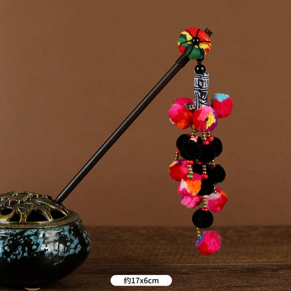 Boho vintage ethnic hair stick pendant featuring colorful pom poms, multi-color beaded accents, and a long orange tassel, displayed alongside an incense burner on a wooden surface against a brown background, ideal for bohemian and traditional fashion enthusiasts in the US 01