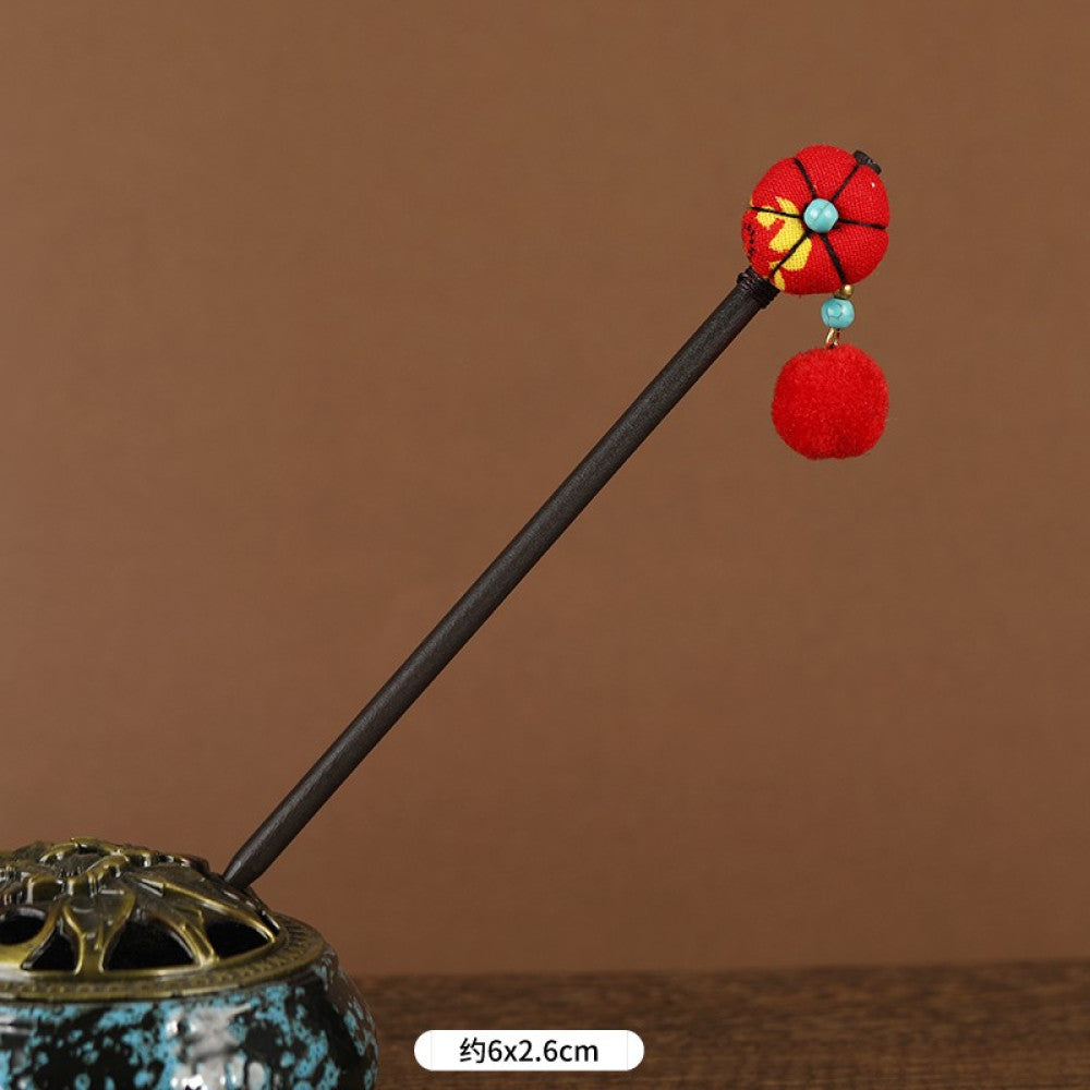 Boho vintage ethnic hair stick pendant featuring colorful pom poms, multi-color beaded accents, and a long orange tassel, displayed alongside an incense burner on a wooden surface against a brown background, ideal for bohemian and traditional fashion enthusiasts in the US 04