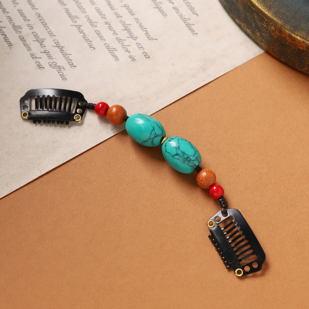 Boho vintage ethnic double hair comb ornament (displayed on a beige surface & text-printed paper background) featuring an evil eye decorative bead, red/yellow beads, and black hair combs, ideal for bohemian retro fashion styling in the US 01