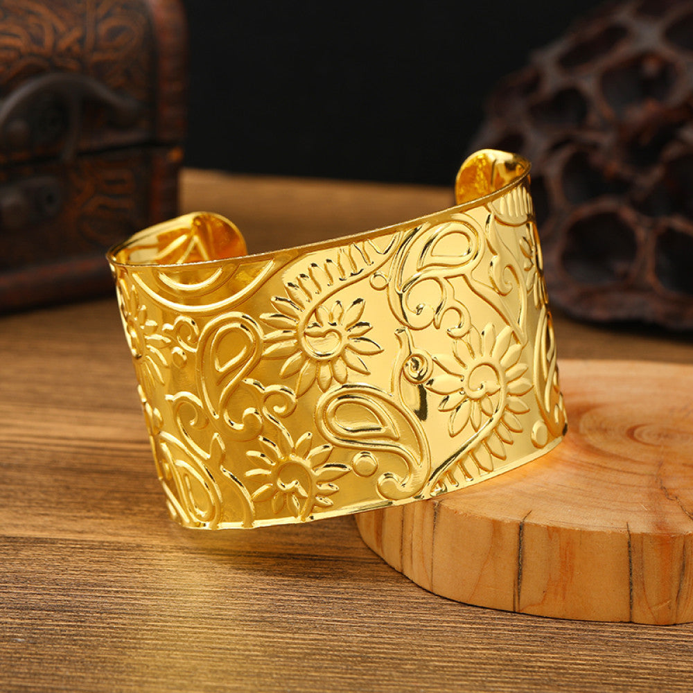 Boho vintage ethnic engraved gold cuff bangle with geometric designs, styled on wooden surface, ideal for bohemian and tribal fashion enthusiasts 06