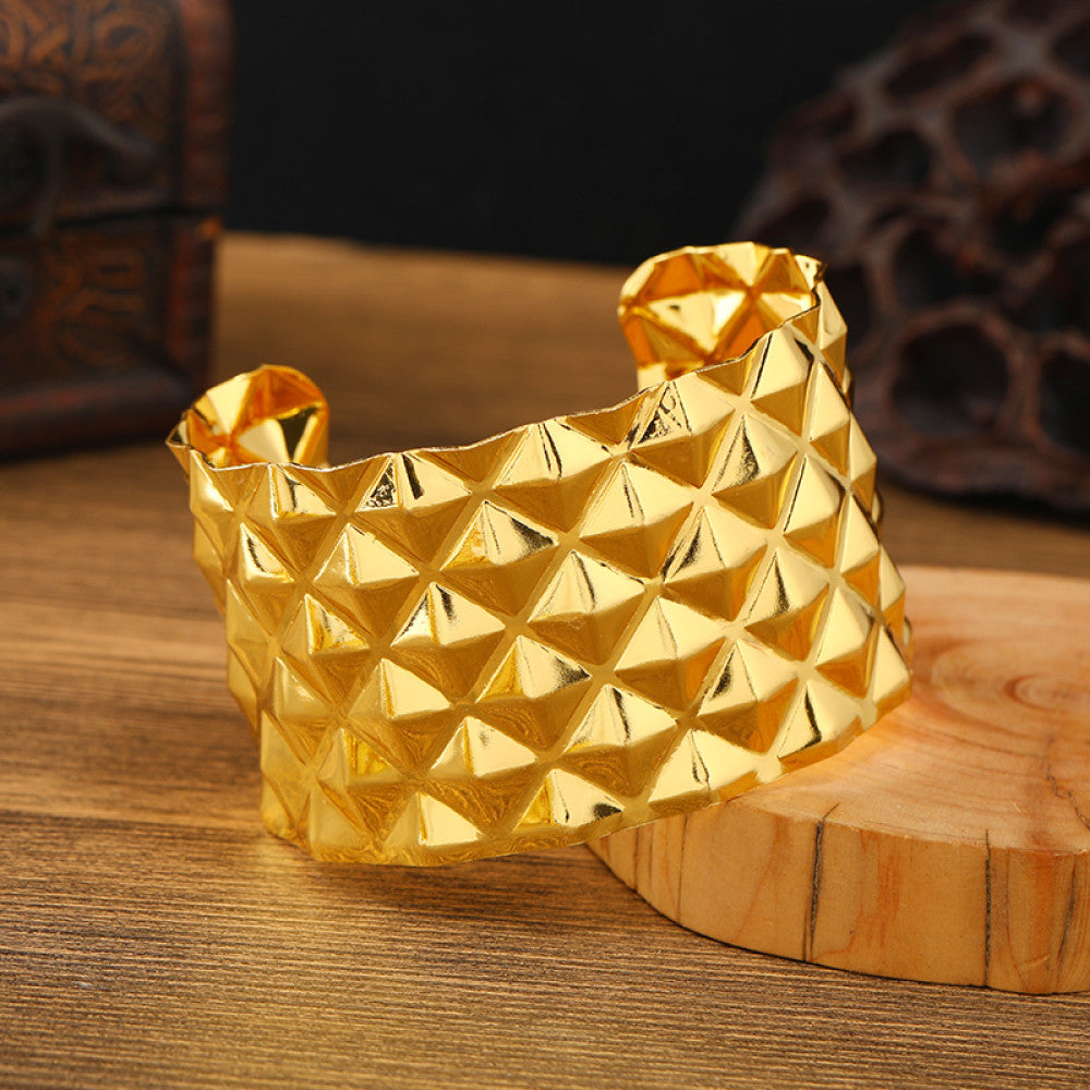 Boho vintage ethnic engraved gold cuff bangle with geometric designs, styled on wooden surface, ideal for bohemian and tribal fashion enthusiasts 08