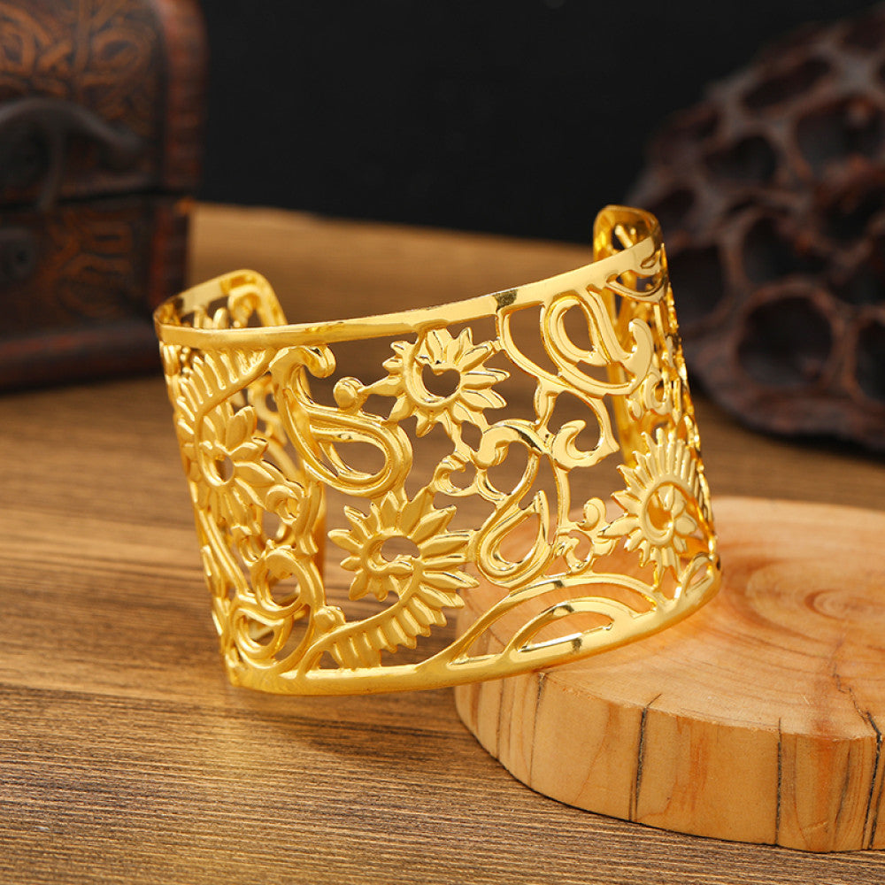 Boho vintage ethnic engraved gold cuff bangle with geometric designs, styled on wooden surface, ideal for bohemian and tribal fashion enthusiasts 10