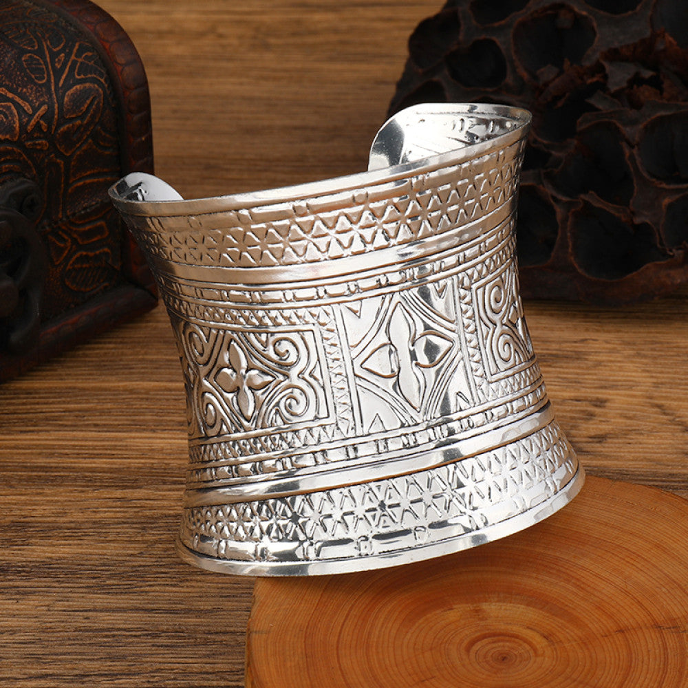 Boho vintage ethnic engraved silver cuff bangle with intricate floral designs, styled on wooden surface, ideal for bohemian and tribal fashion enthusiasts in the US 02