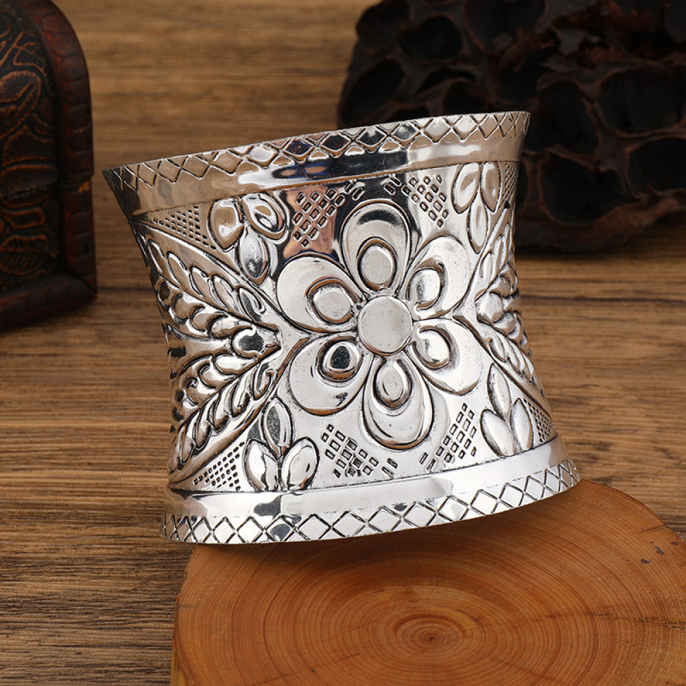 Boho vintage ethnic engraved silver cuff bangle with intricate floral designs, styled on wooden surface, ideal for bohemian and tribal fashion enthusiasts in the US 03