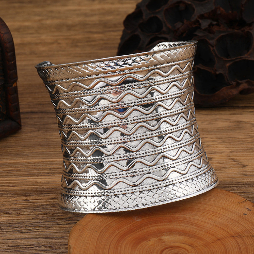 Boho vintage ethnic engraved silver cuff bangle with intricate floral designs, styled on wooden surface, ideal for bohemian and tribal fashion enthusiasts in the US 05